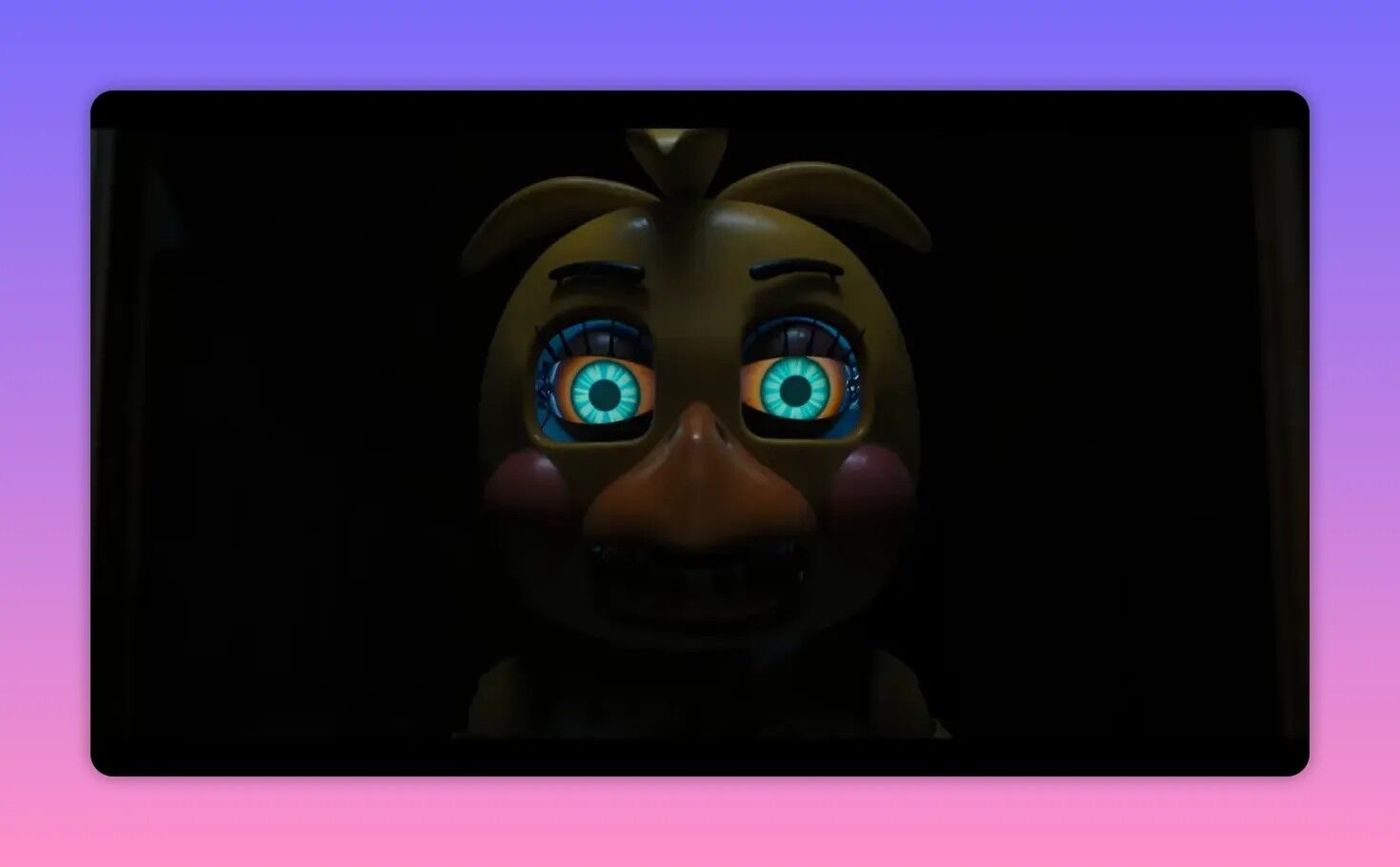 Front-facing animatronic face with bright mechanical eyes in a dark frame