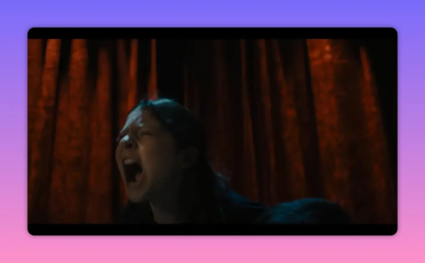 Child yelling or screaming with red theatrical curtains behind them, suggesting a staged reveal