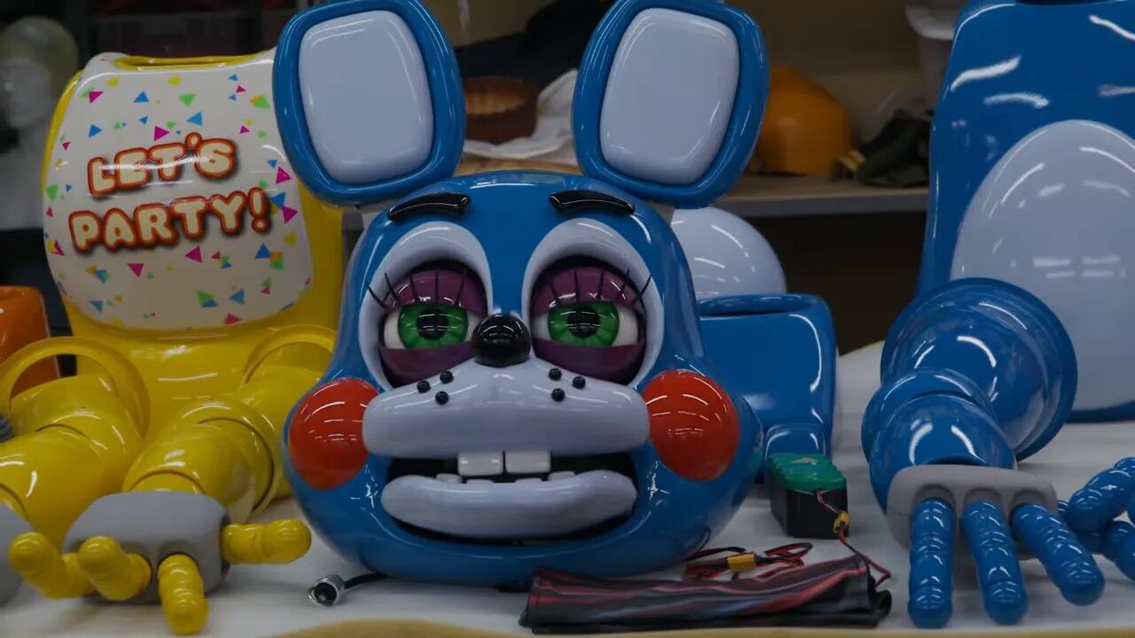 Blue animatronic head and detachable limbs on a work table